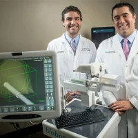 Jeffrey Nix, M.D., left, and Soroush Rais-Bahrami, M.D., with the iSR’obot Mona Lisa, a new image-guided device for diagnosing prostate cancer prostate cancer