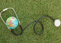 Stethoscope wrapped around globe symbolising global healthcare and medical access 