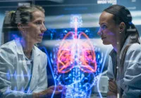 Doctors discussing patient case with holographic anatomy display in high-tech medical facility 