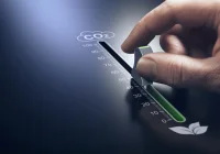 Hand adjusting a control knob to reduce CO₂ emissions, representing environmental sustainability, carbon footprint reduction, and green innovation efforts. 