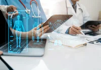 Digital health teamwork: clinicians reviewing 3D anatomy and electronic records in a hospital meeting. 