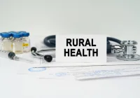 Rural healthcare concept — stethoscope, vaccine vials and syringe on medical paperwork. 