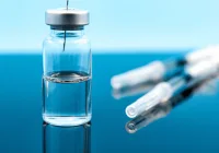 Close-up of a medical vial with a syringe needle, symbolising the precision handling of injectable therapies in clinical and laboratory settings.