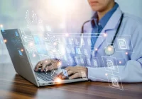 Healthcare professional working on a laptop with a digital interface showing connected medical records and AI-driven data workflows.