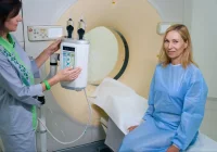 Patient preparing for CT scan with contrast injector, supporting diagnostic imaging, radiology workflow and patient care.