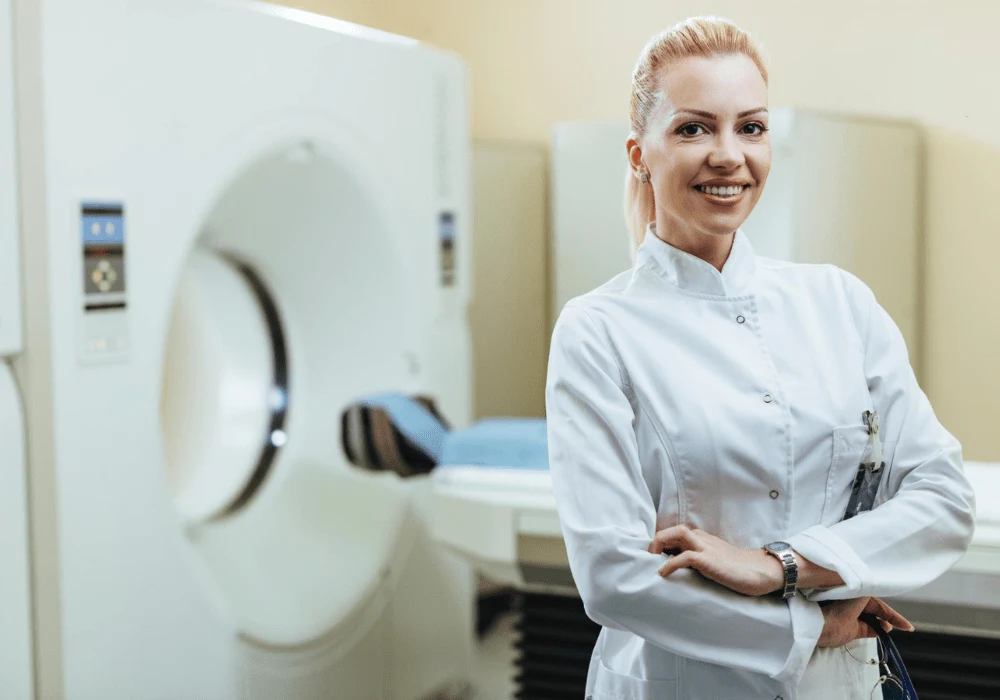 Confident Radiologist in MRI Room – Female Doctor Standing with Arms Crossed