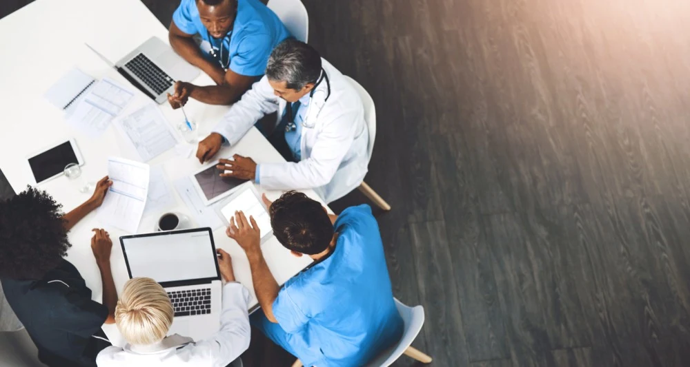 Top view of a diverse medical team collaborating on patient care and treatment planning 