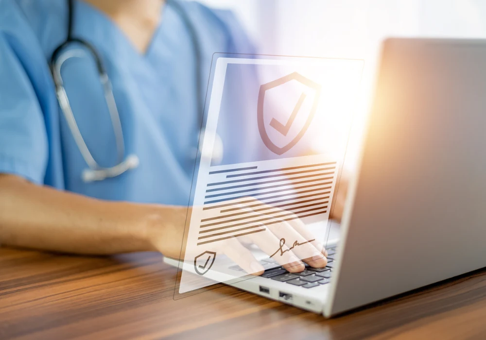 Doctor using laptop with secure digital health records interface symbolising data protection in healthcare IT 
