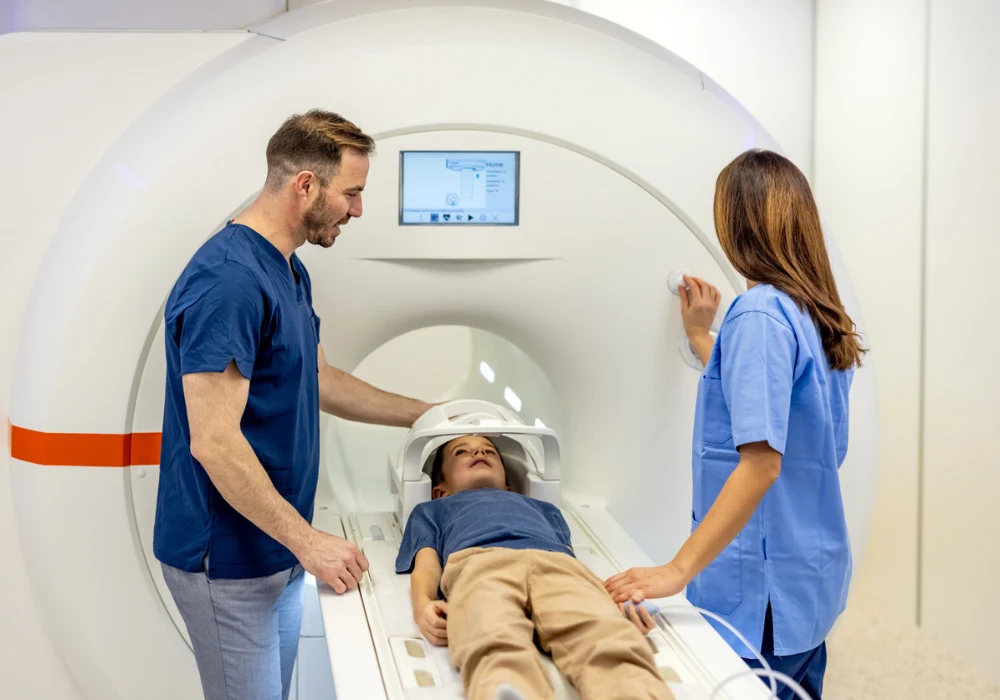 Paediatric MRI scan preparation with medical staff assisting a child in a modern imaging centre. 