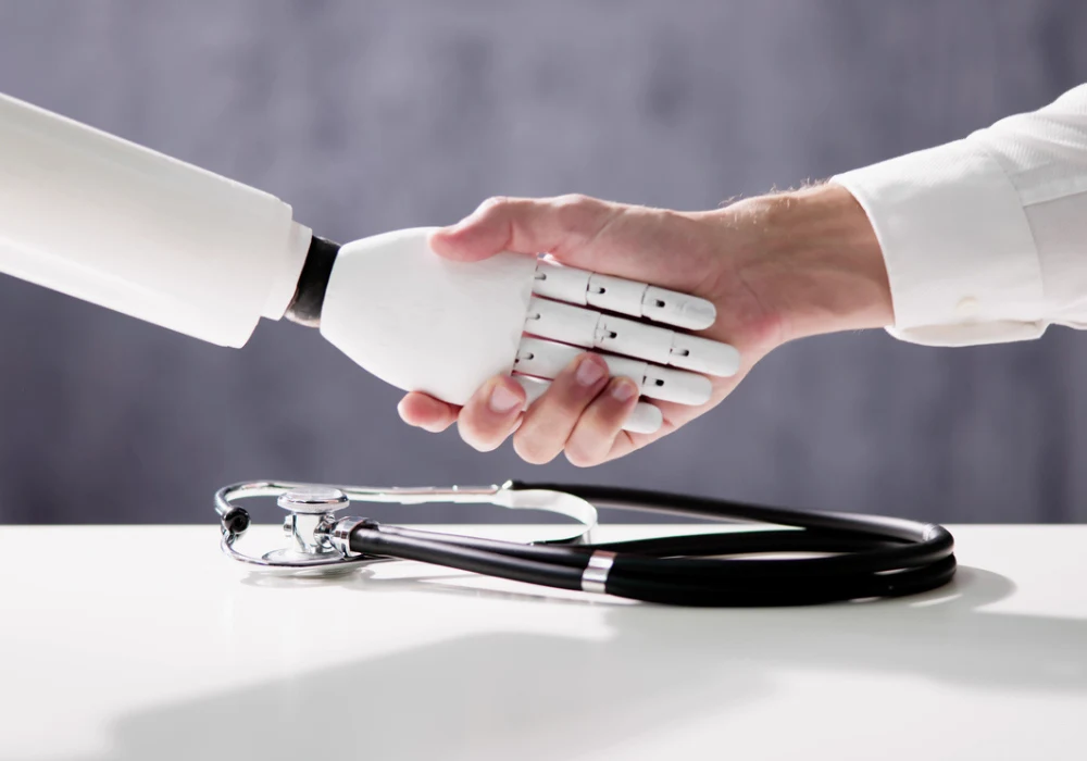 Human doctor shaking hands with a robot, symbolising collaboration between AI and healthcare 