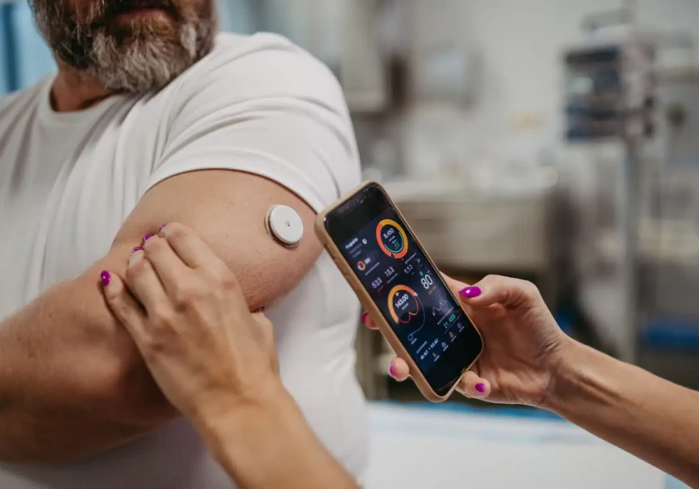  Continuous glucose monitor linked to mobile app display. 