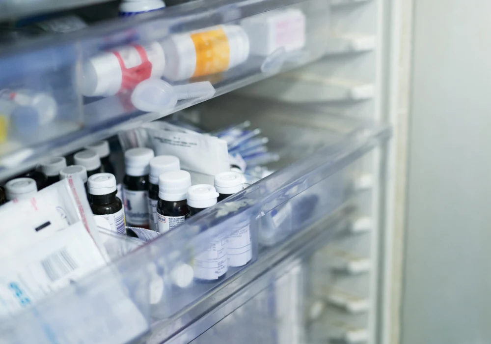 Hospital medication refrigerator with organised vials and supplies, illustrating controlled storage and inventory management in clinical pharmacy settings.