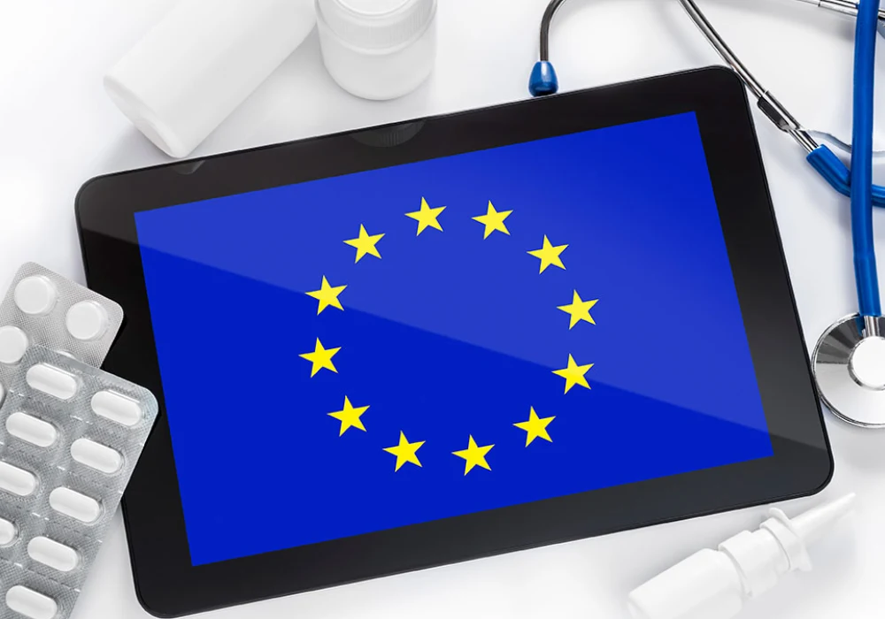 EU flag on a medical tablet with stethoscope and medicines. 