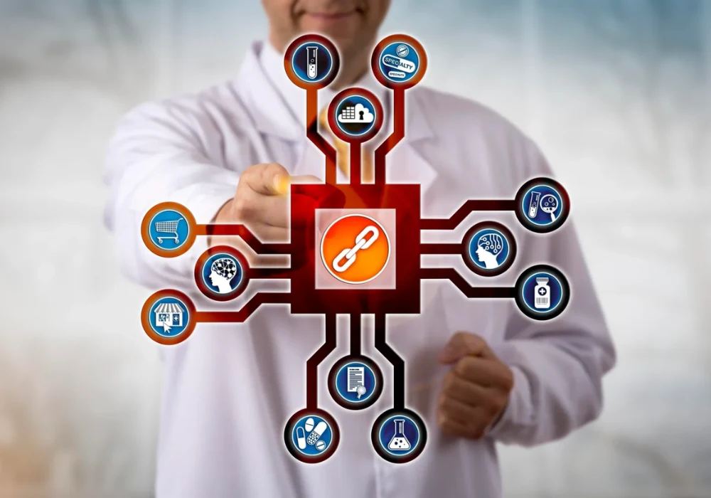 Clinician engaging with a digital network centred on a chain icon, illustrating interconnected healthcare data, interoperability and the integration of multiple clinical and operational systems across the care continuum.