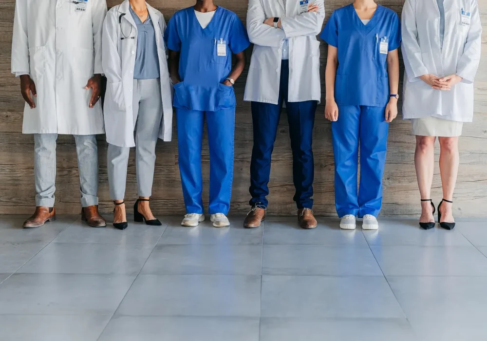Multidisciplinary healthcare team standing together, supporting hospital workforce planning, clinical collaboration and coordinated patient care.