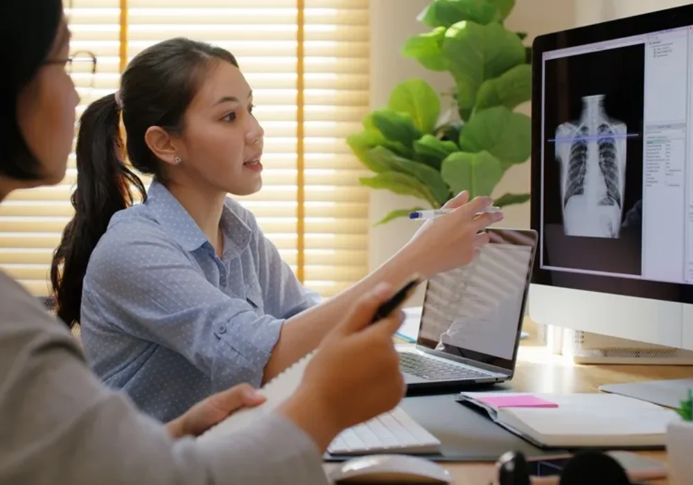 Clinicians reviewing chest x-ray images on a digital workstation, supporting radiology assessment, AI development and diagnostic decision-making.