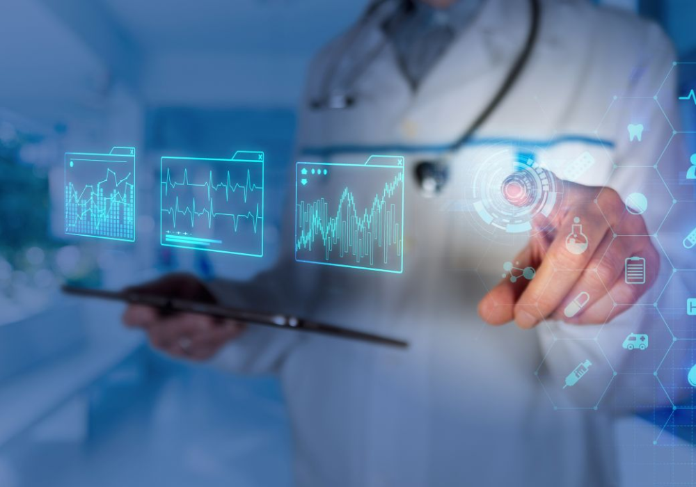 Clinician interacting with a digital interface displaying clinical metrics and patient data, illustrating real-time analytics, decision support and data-driven care in a connected healthcare environment.