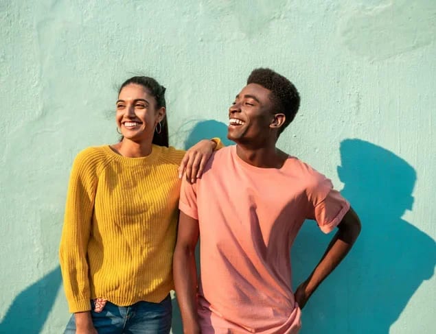 Happy young couple laughing and smiling in the afternoon sun