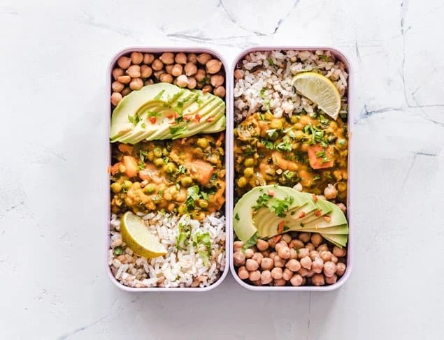 Two lunchboxes side by side with a meal made from non-perishable foods chickpeas and rice