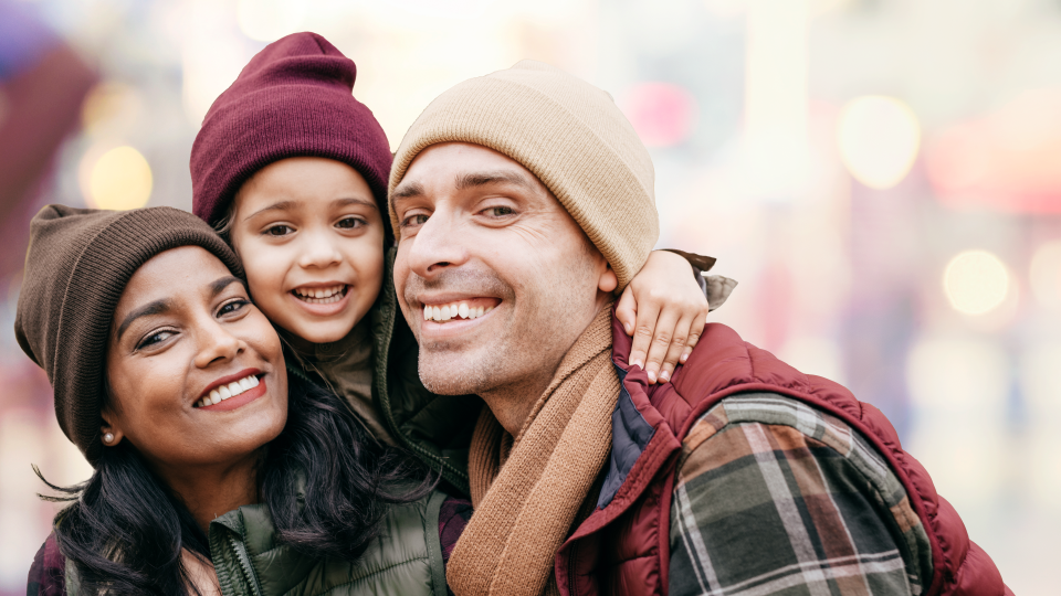 Photo of smiling family, a couple and their daughter