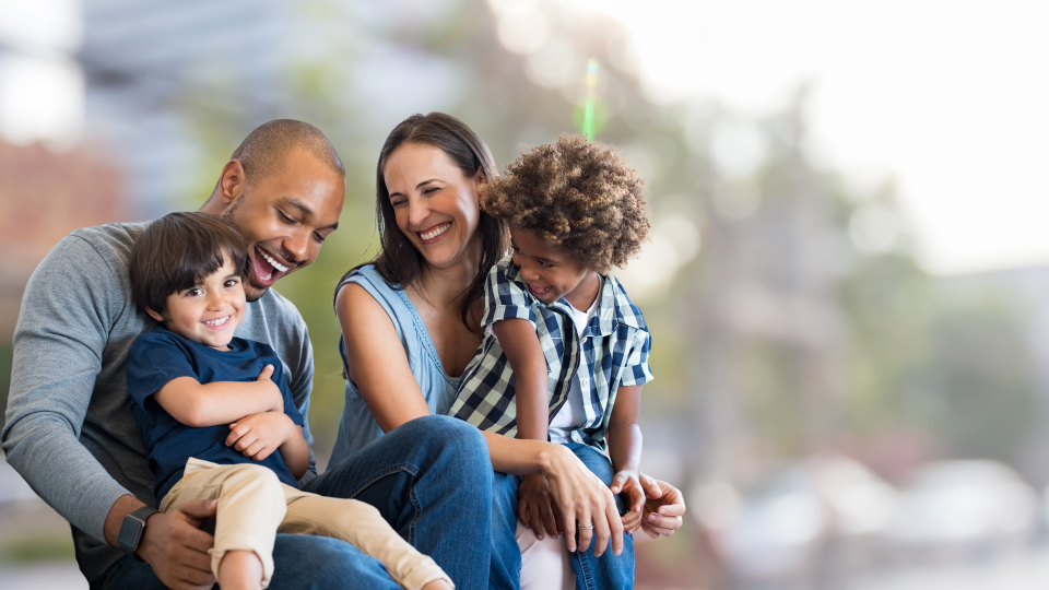 Photo of smiling family, a couple and their two sons