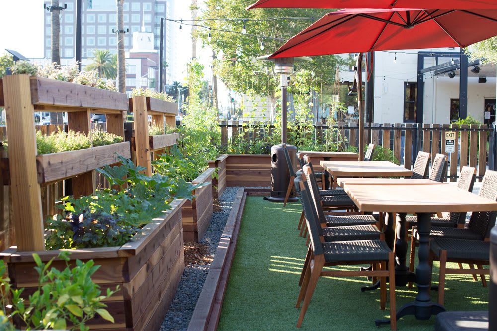 Garden Seating area at Poppy & Seed restaurant in Anaheim, CA full of raised garden beds | Photo by Nicole Kent