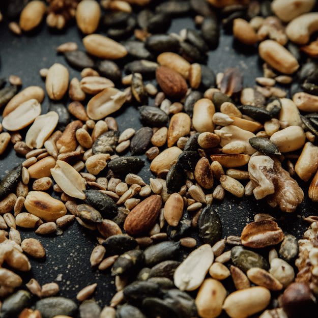 SaladNuts_web Salad Philosophy: Close up image of seeds + nuts: peanuts, pumpkin seeds, sunflower seeds