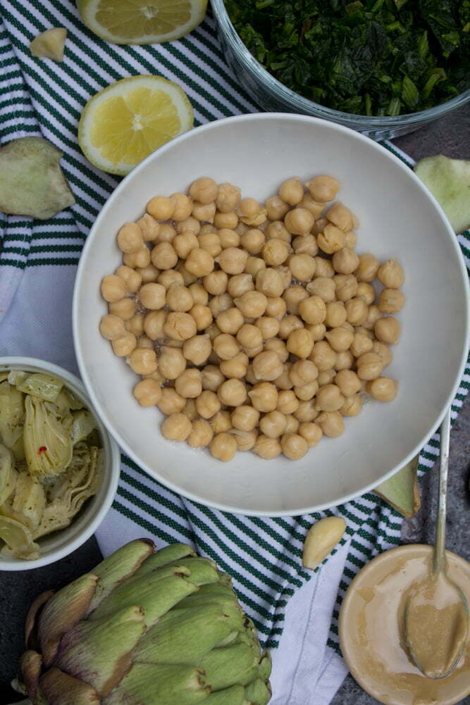 Vegan ingredients for Spinach Artichoke Hummus | Garbanzo beans, marinated artichoke hearts, lemon, frozen spinach, and tahini