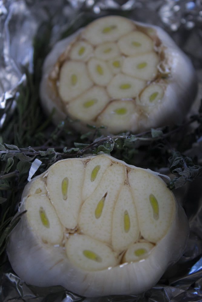 Pre-roasted heads of garlic to make roasted garlic with herbs