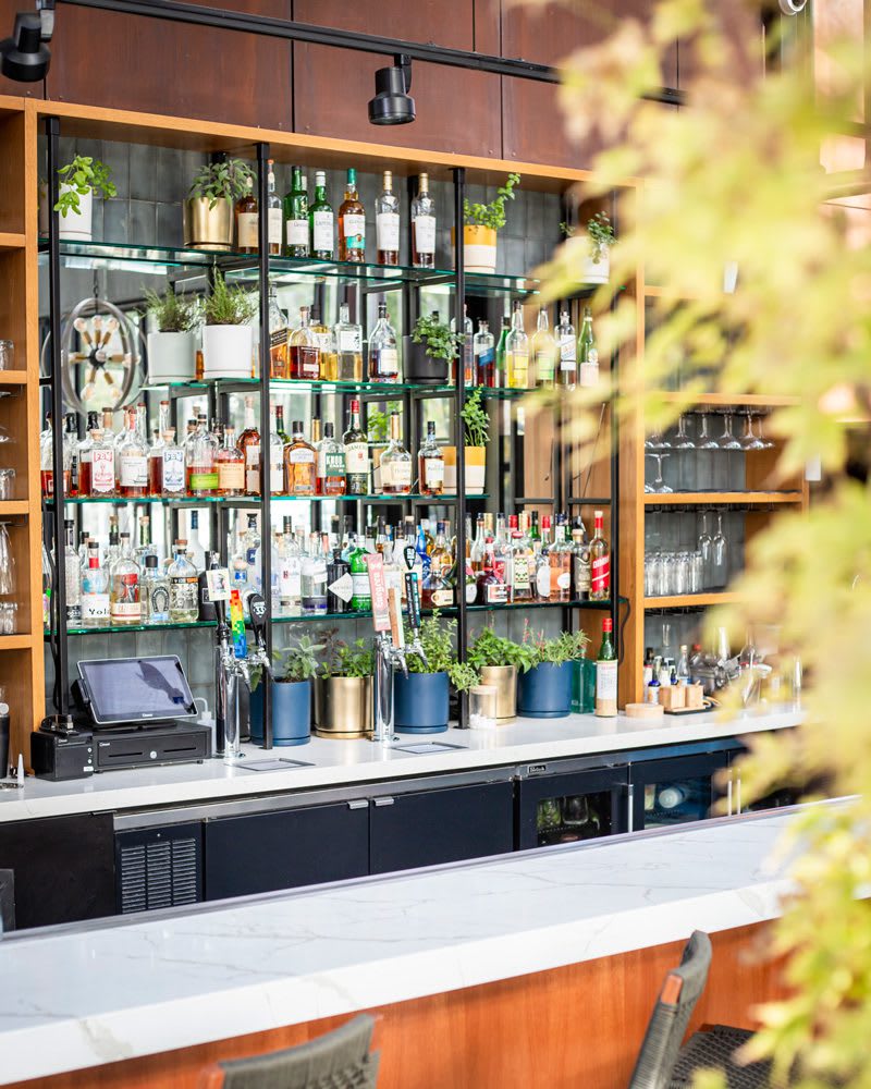 heirloom-potager-poppy-bar_1P_web Close up view of library bar at Poppy & Seed in Anaheim, CA full of unique liquor and fresh garden herbs | Photo by Jill Cook