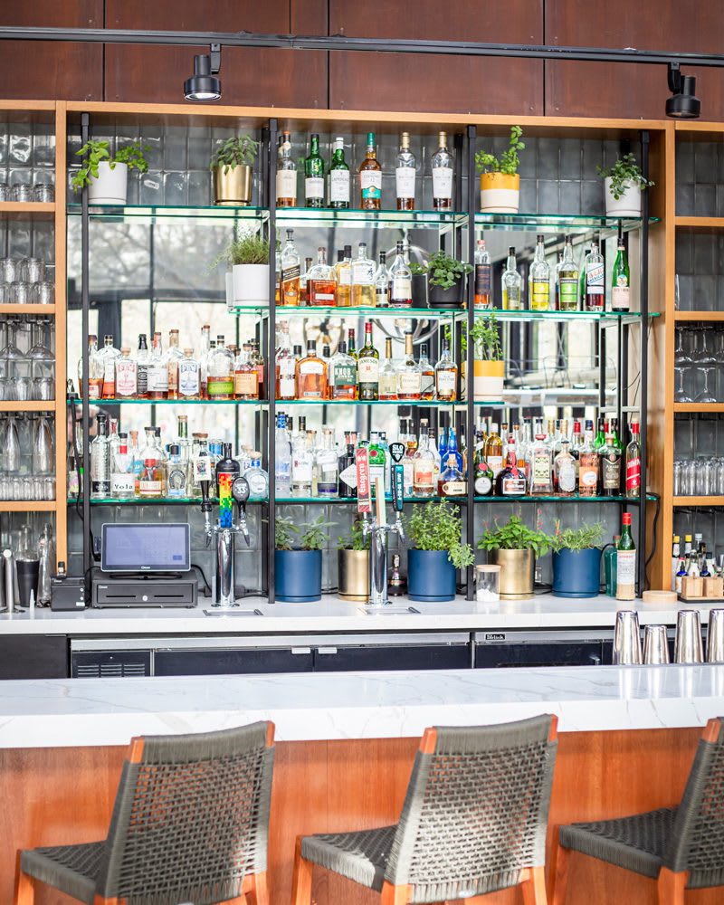 heirloom-potager-poppy-bar-1P_web Library bar at Poppy & Seed in Anaheim, CA full of unique liquor and fresh garden herbs | Photo by Jill Cook