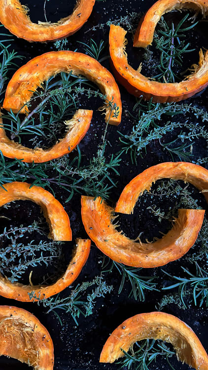 HoneyThymePumpkin1_web Honey Thyme Pumpkin Hummus | Slices of small pumpkin placed on a baking sheet seasoned with olive oil, salt and pepper, and placed upon fresh thyme and rosemary.