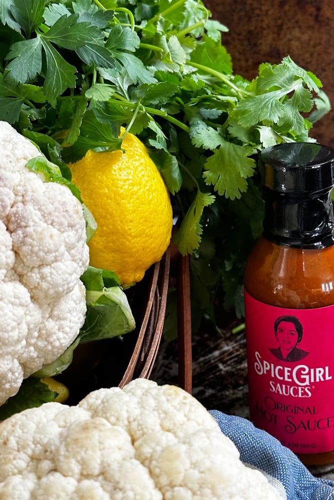 Ingredients for spicy cauliflower steaks served over green goddess hummus