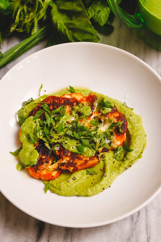 SpicyCauliflowerSteaks_GreenGoddessHummus_w6 Spicy cauliflower steak served with fresh tender herbs and green goddess spring hummus.