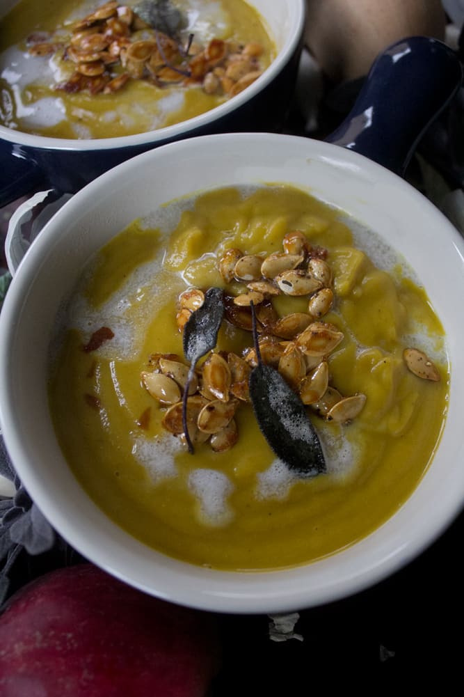 Ingredients for winter squash soup - onions, apples, sage, garlic, and squash