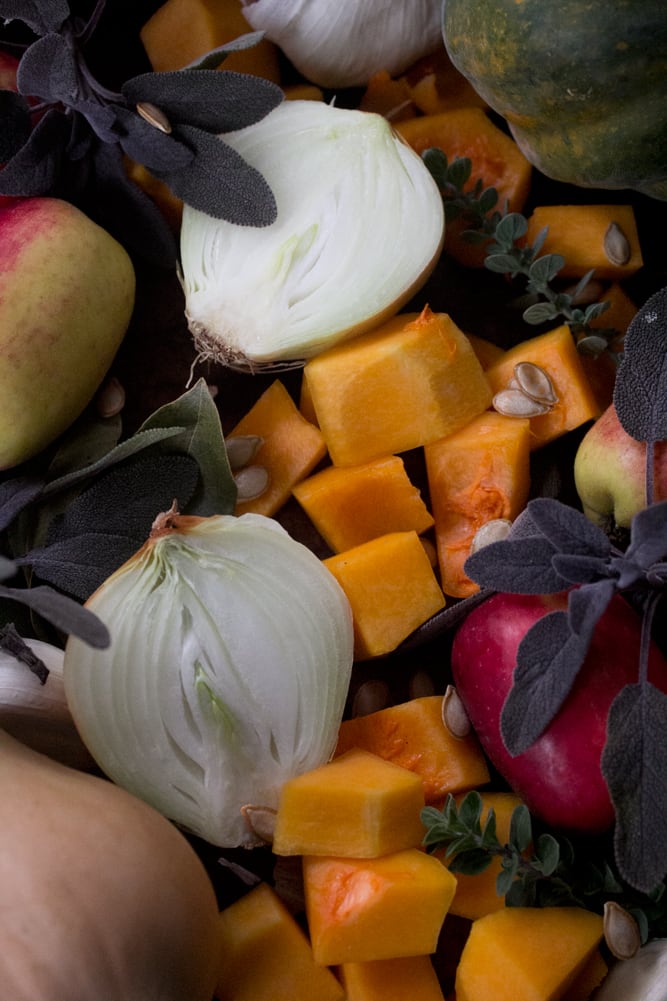Ingredients for winter squash soup - onions, apples, sage, garlic, and squash