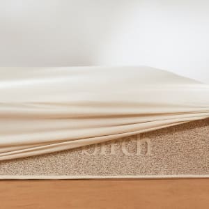 The waterproof mattress protector pulled over the Birch Natural Mattress
