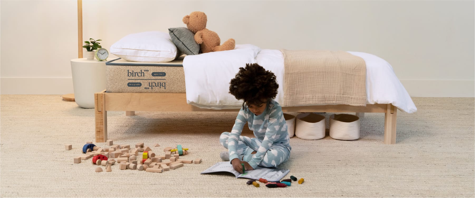 Birch Kids Mattress on a wood bed frame in a room