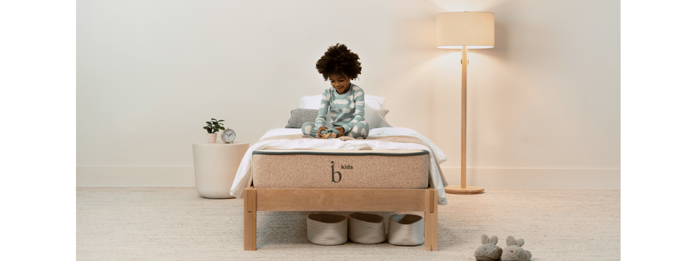 Toddler playing with blocks on Birch Kids bed