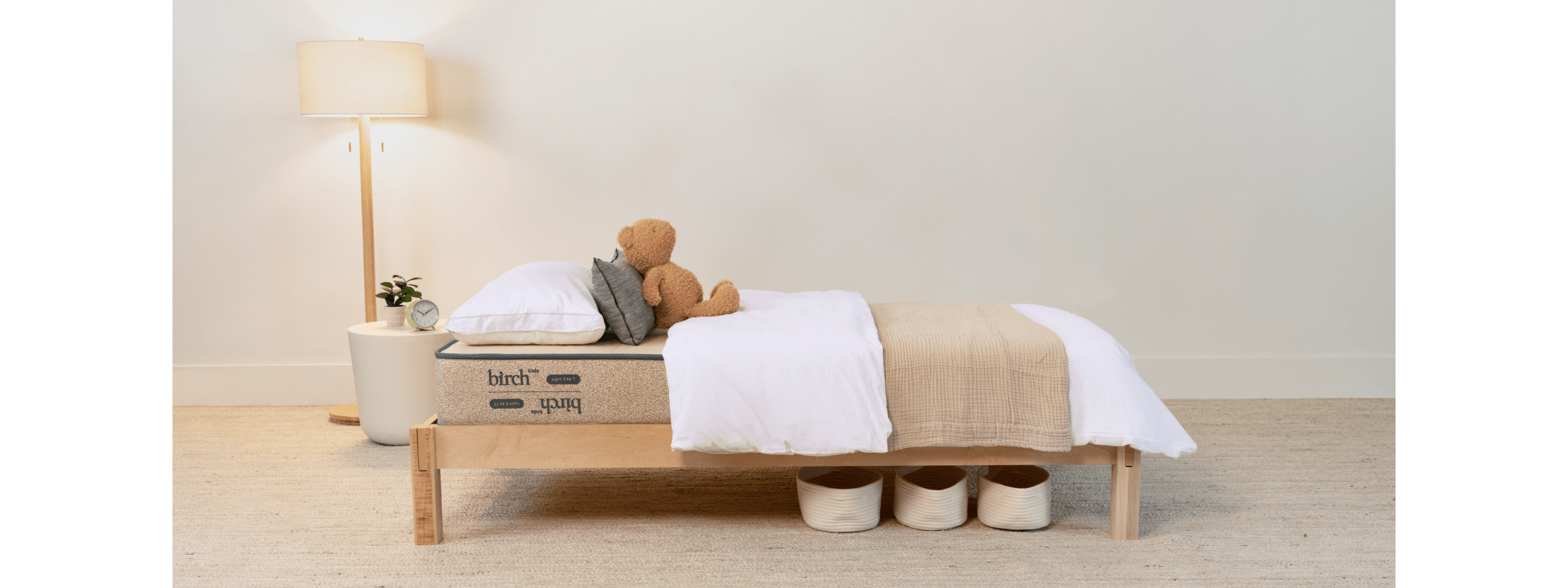 Birch Kids mattress with pillows and stuffed bear