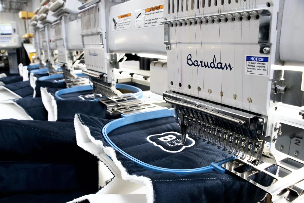 Sewing machines embroidering Brooklyn Bedding on Mattress fabric