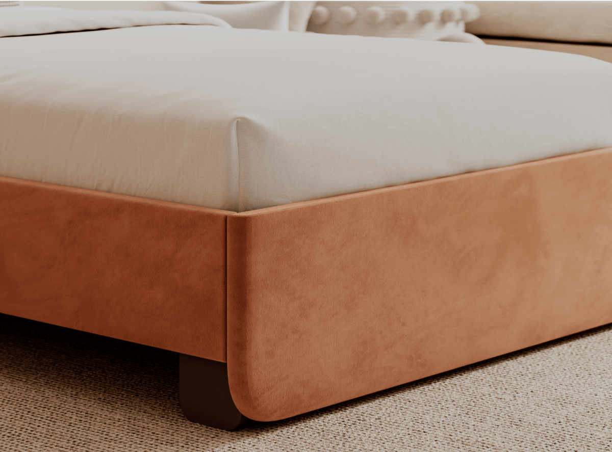 The Helix Astor Bed Frame in a rose color positioned in a bedroom setting