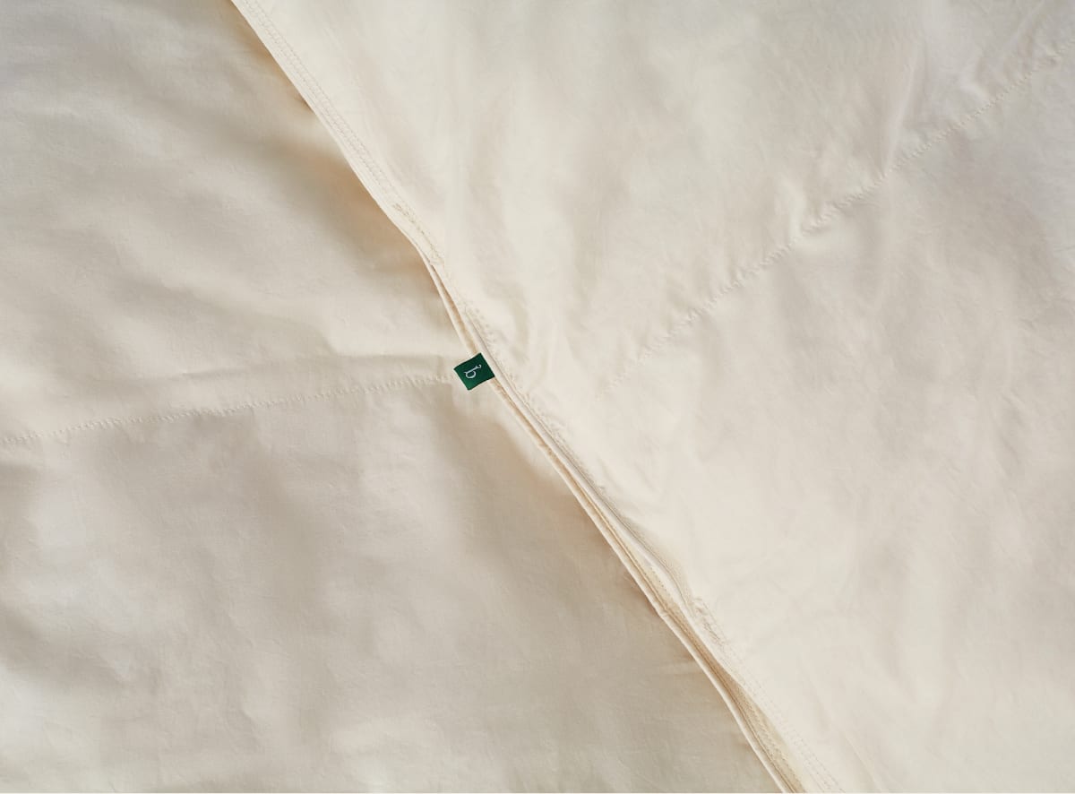 The Duvet Insert draped across the surface of a Birch mattress