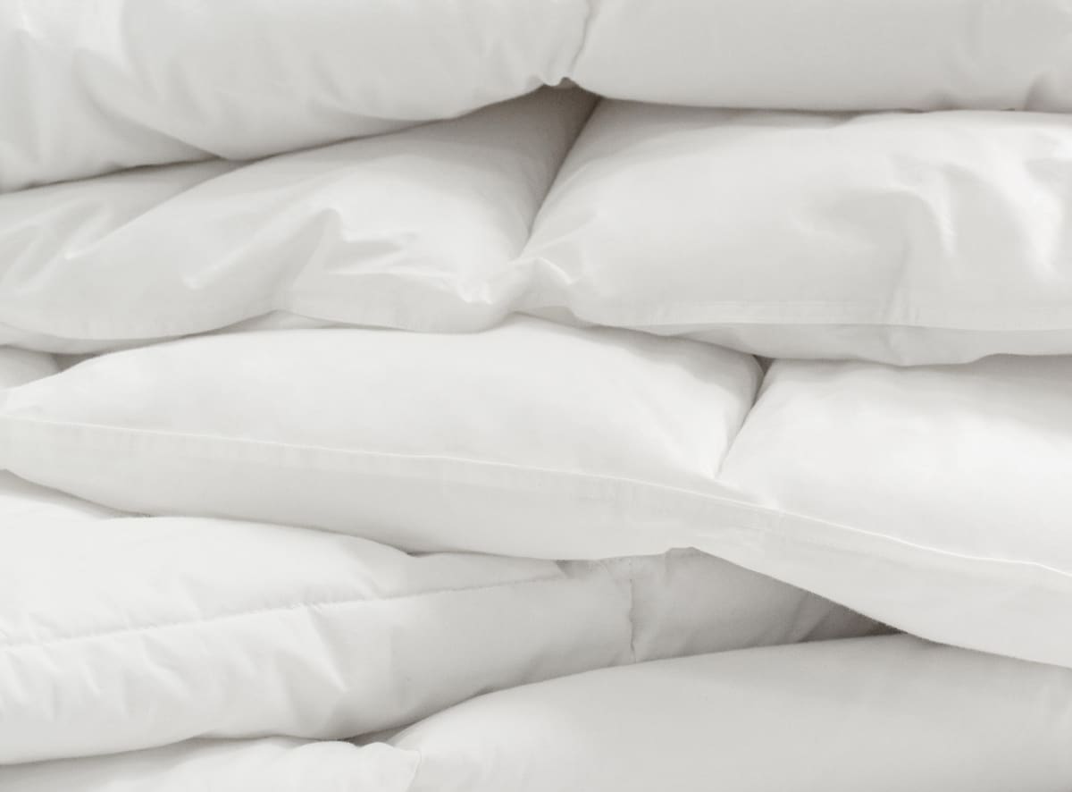 A closeup of the Duvet Insert stacked to show its loft and cozy design