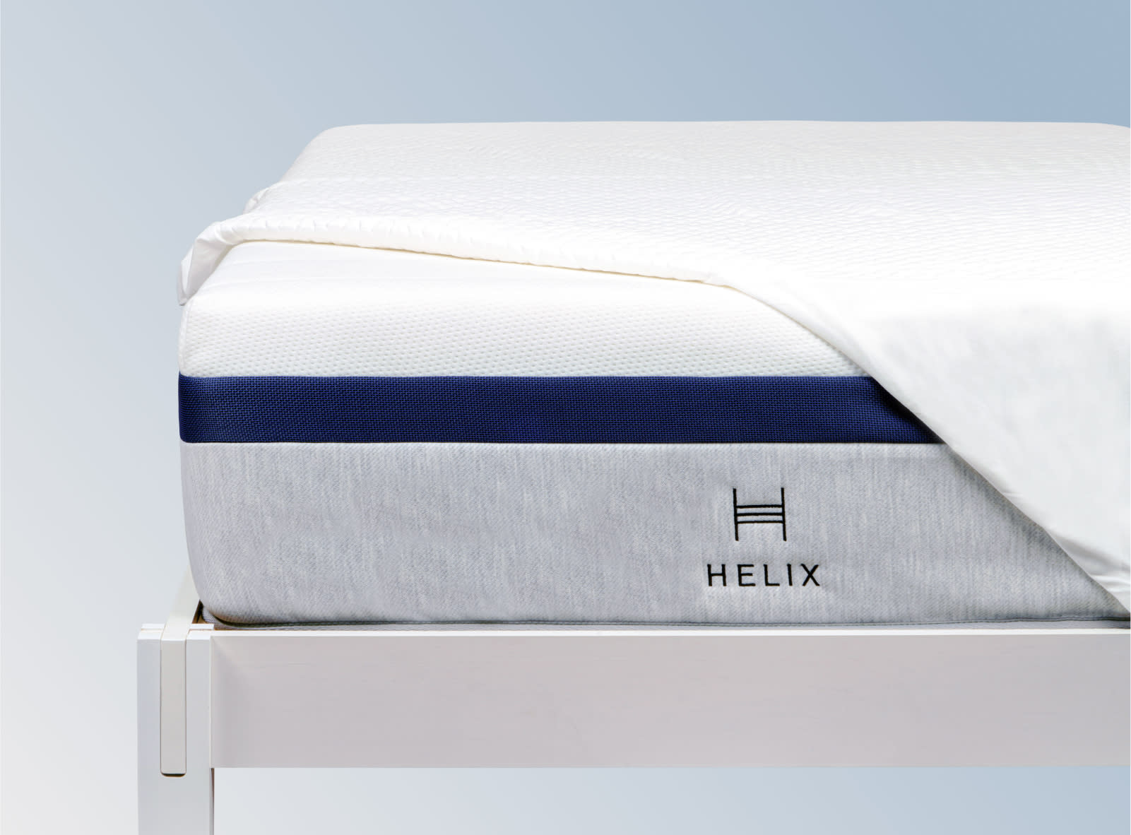 The Helix GlacioTex Waterproof Mattress Protector on a blue background.