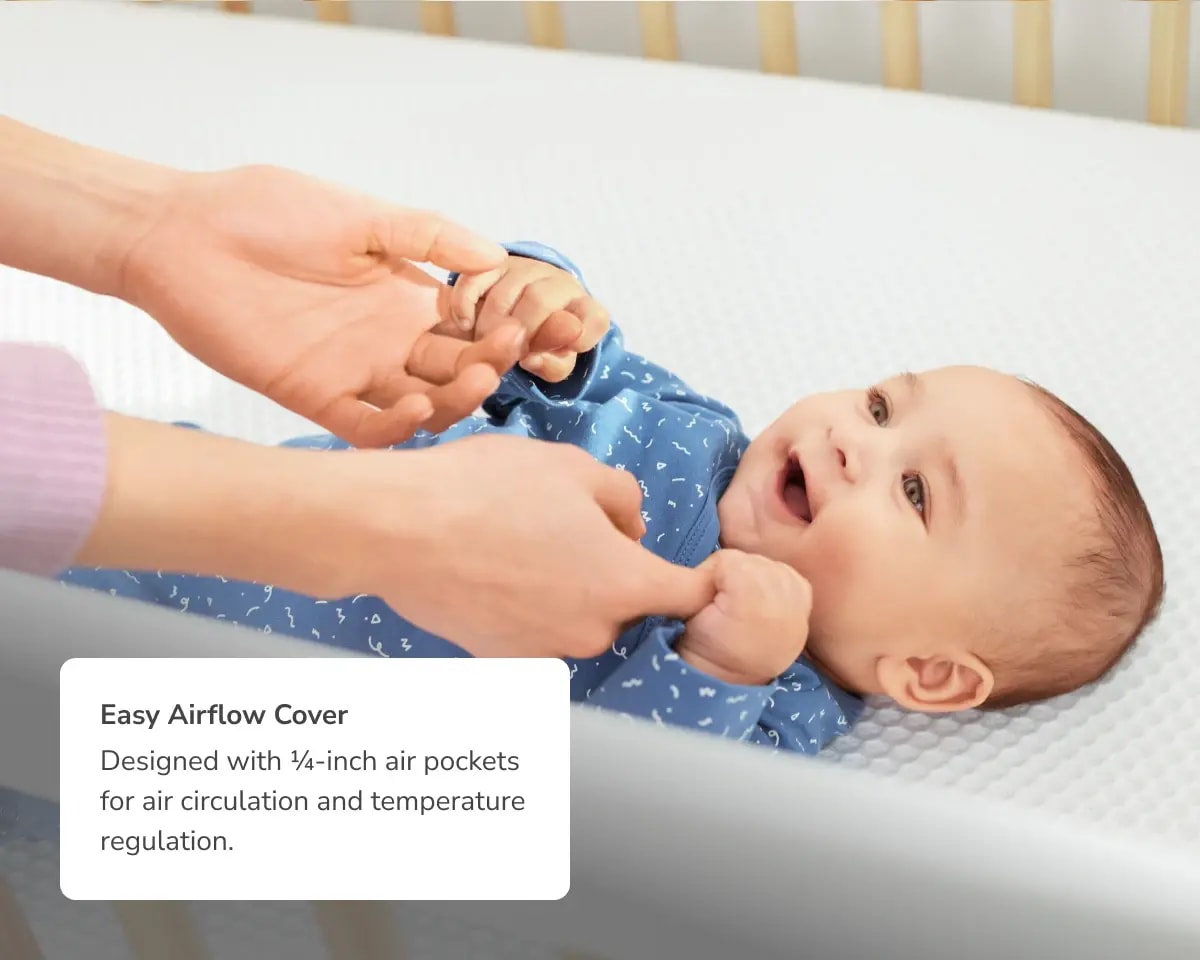 An image of a child on the Helix Crib Mattress with a callout to the Easy Airflow Cover for air circulation