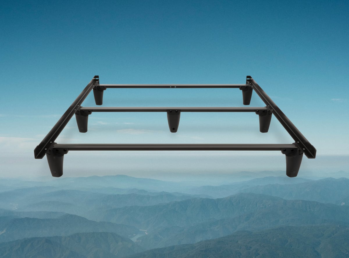 An image of the metal bed frame on a mountain scene background