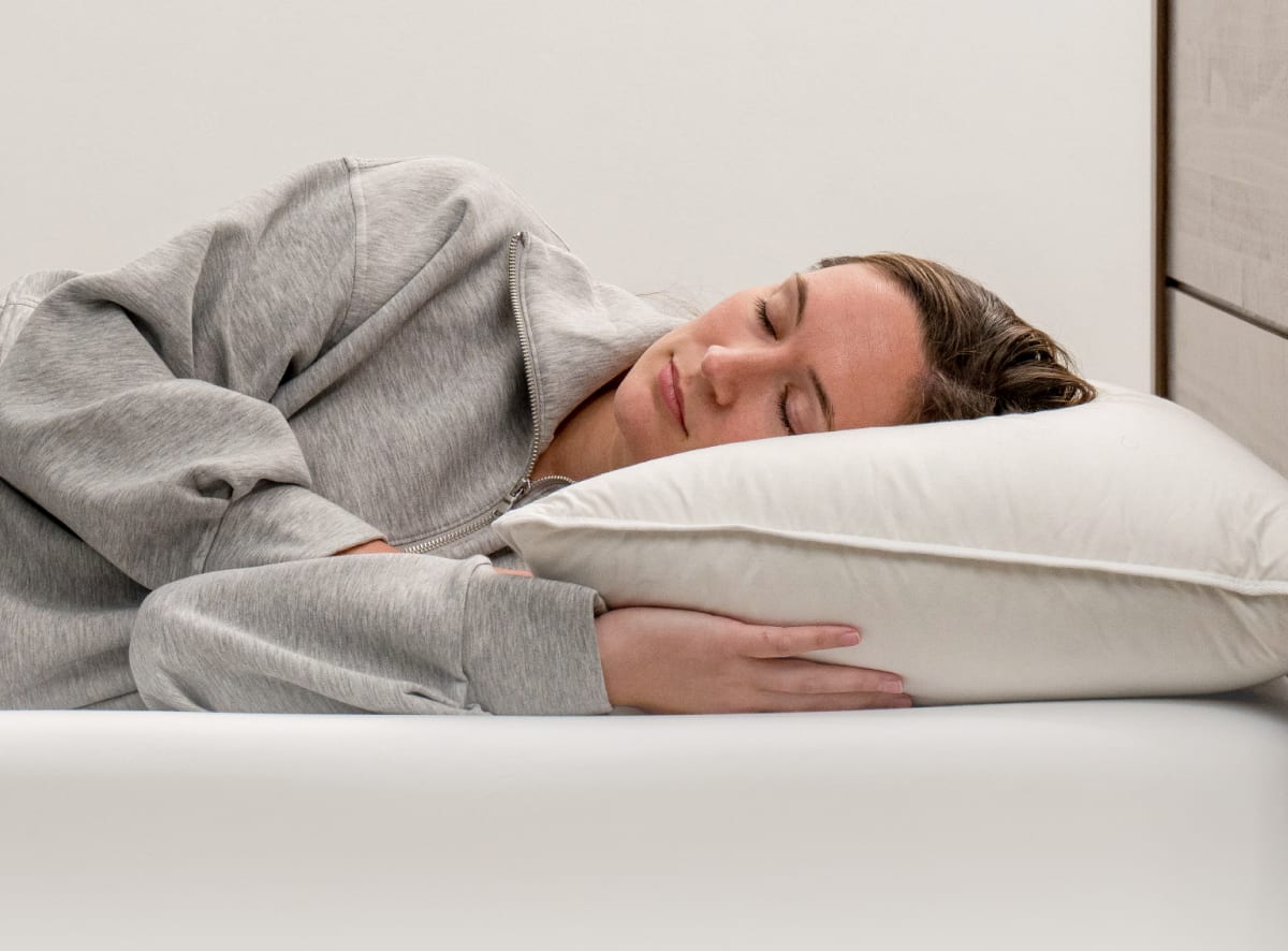 The Down and Feather pillow in a bedroom scene with a side sleeper