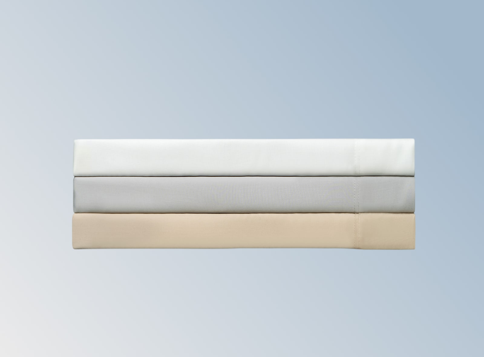 3 sets of tencel sheets stacked on a blue background