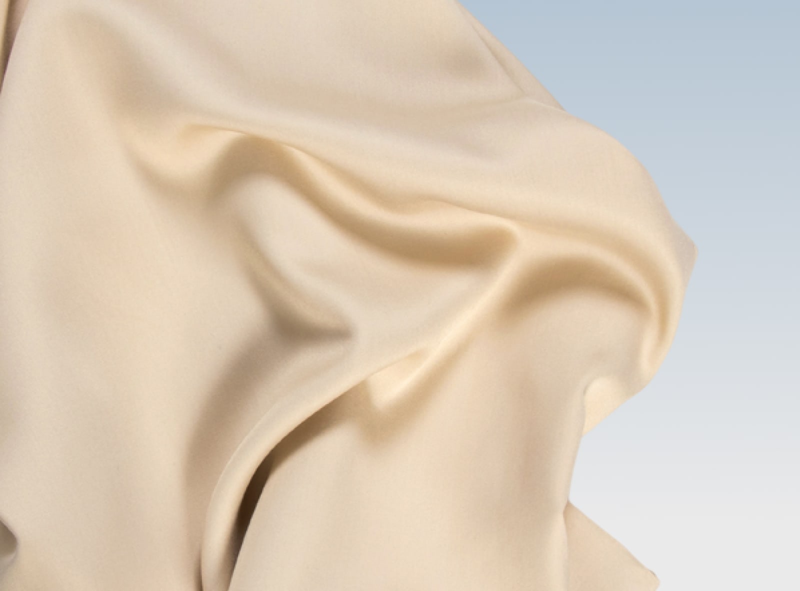 Khaki tencel sheets rumpled on a blue background